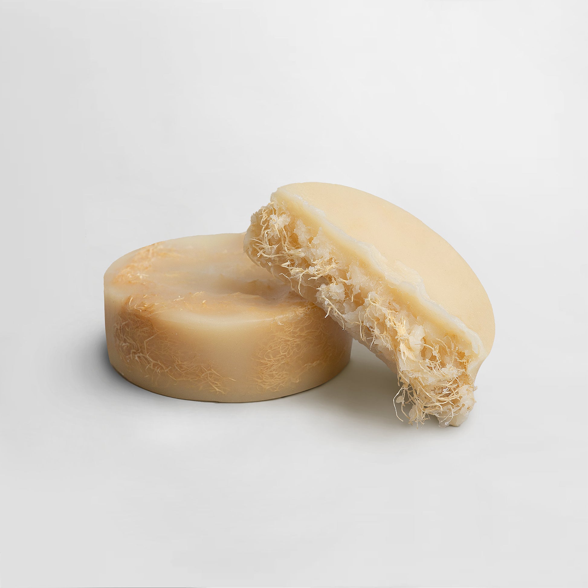 Bar of soap with a natural texture on a light gray background